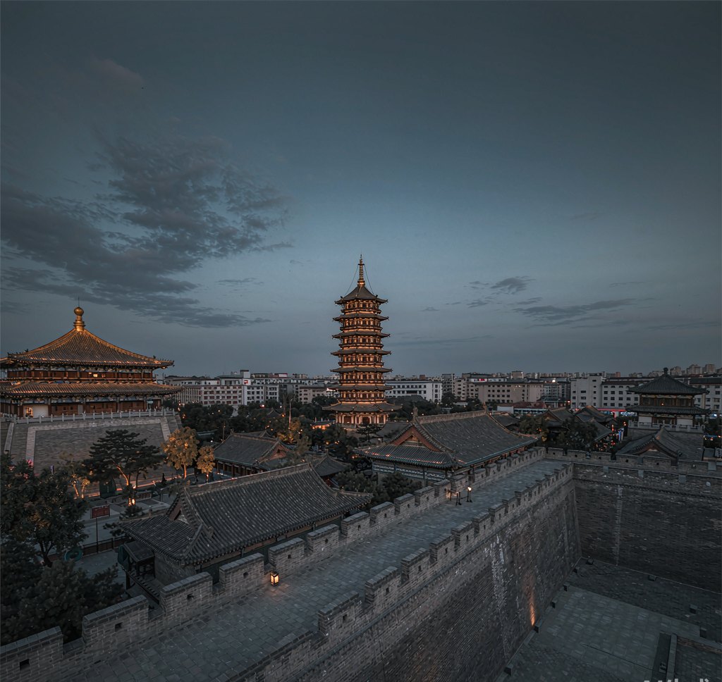 Ancient city wall and Tang-dynasty rooftops at dusk in Xi'an, China